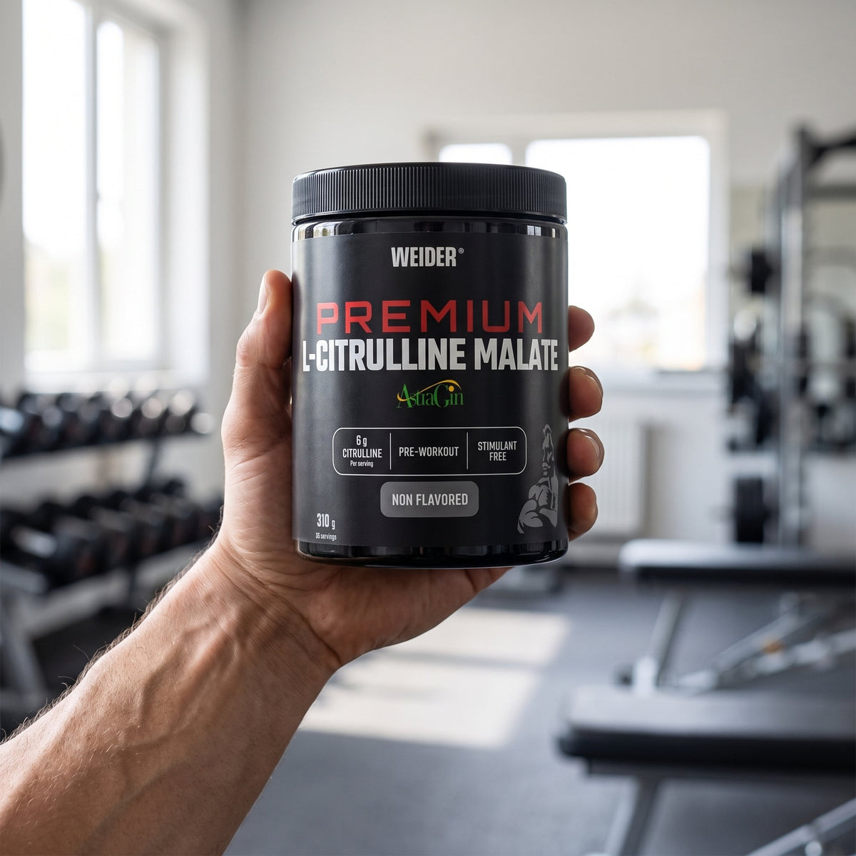 Weider Citrulline Malate, held in the hand in a gym