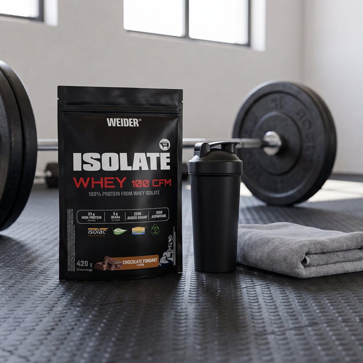 Weider Whey Protein, Isolate, on a gym floor beside a shaker