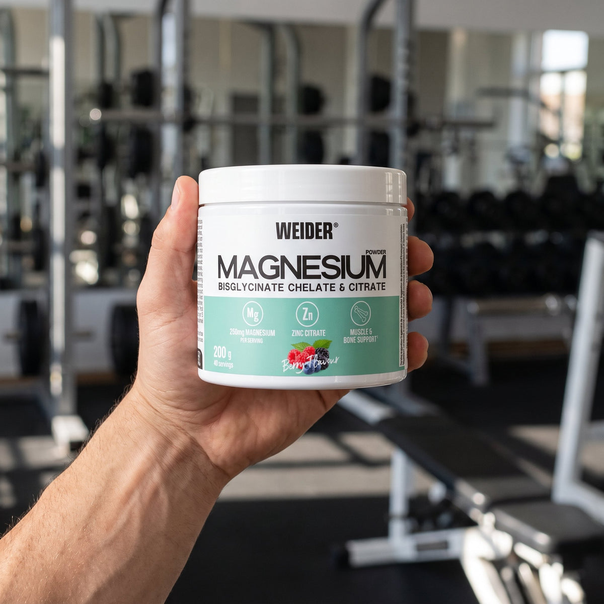 Weider Magnesium Powder, held in the hand in a gym