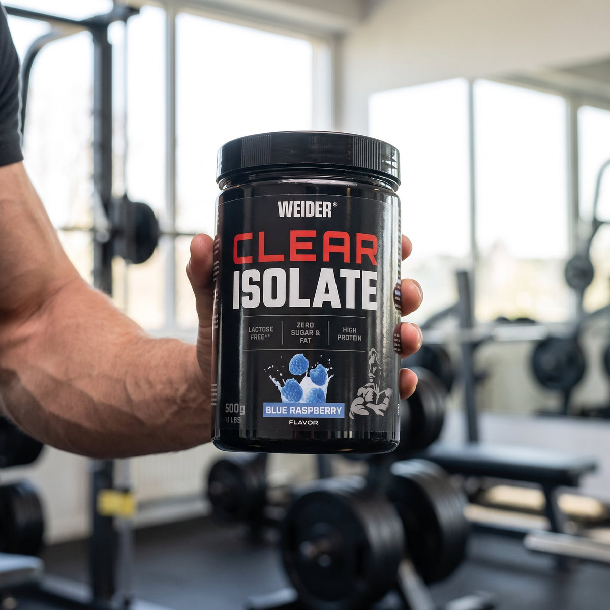 Weider Clear Whey Protein, held in the hand in a gym