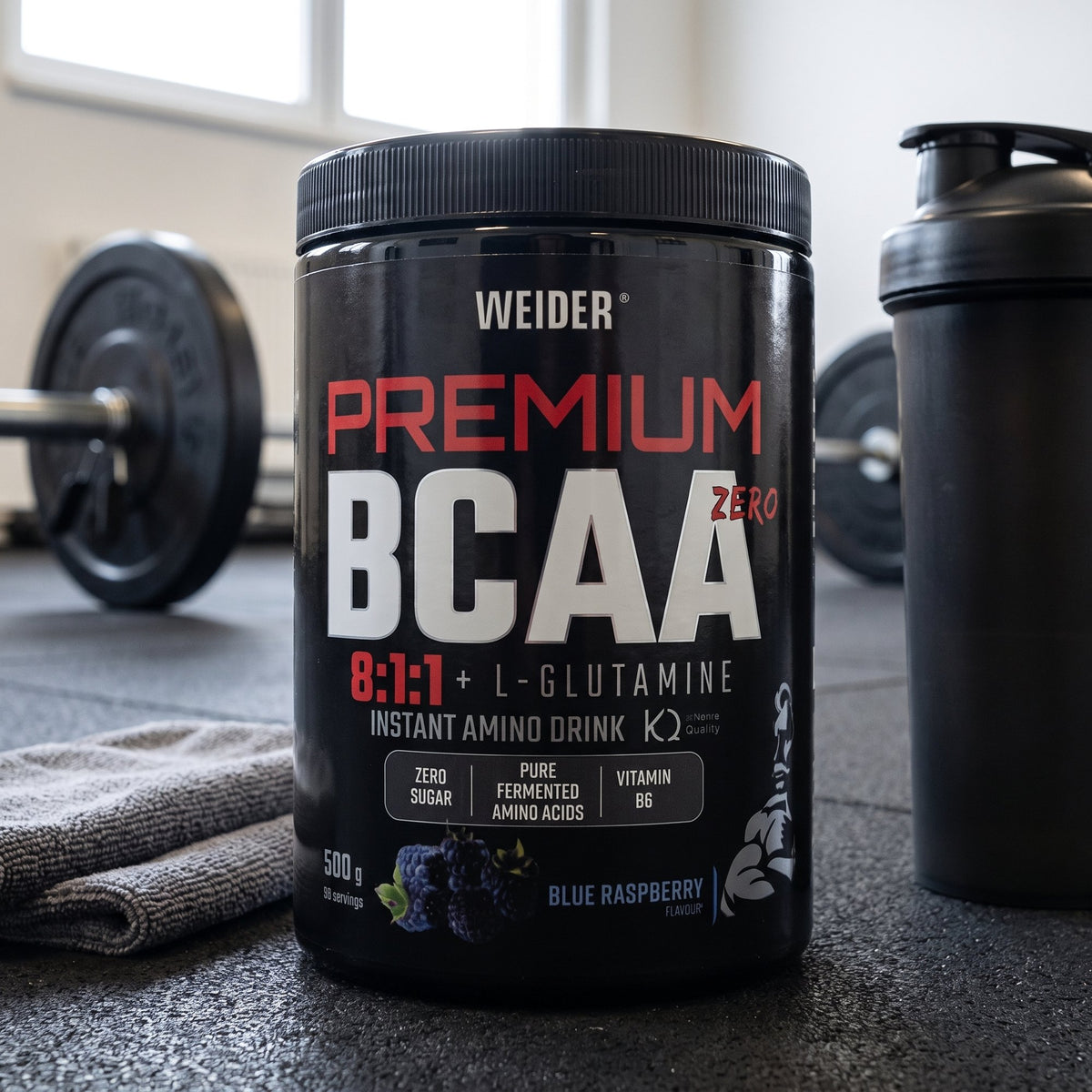 Weider BCAA and Glutamine, on a gym floor beside a shaker