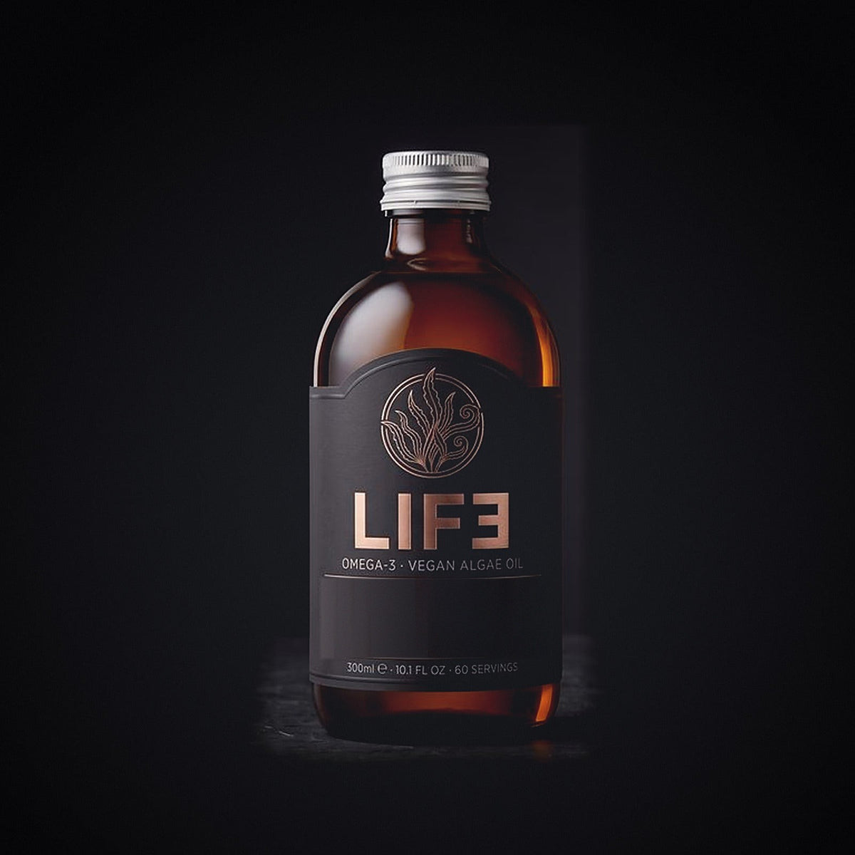 LIF3 Vegan Algae Oil in a 300 ml amber apothecary bottle, engraved algae crest in rose gold on black