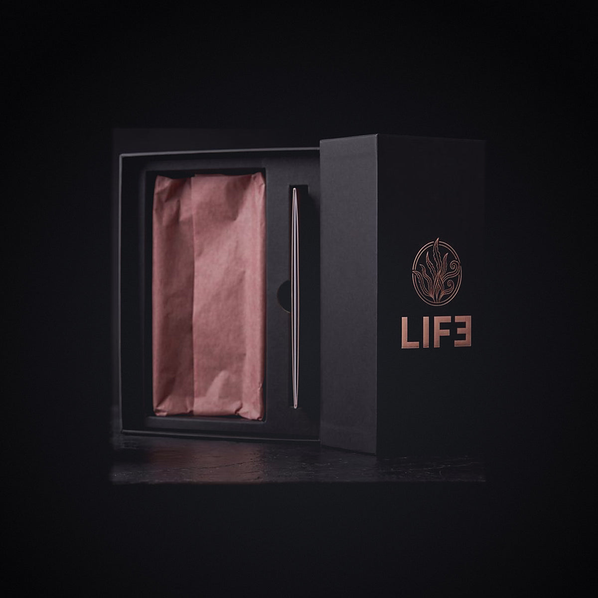 The LIF3 Vegan Algae Oil gift box open, rose tissue and fitted tray, algae crest in rose-gold foil on the lid