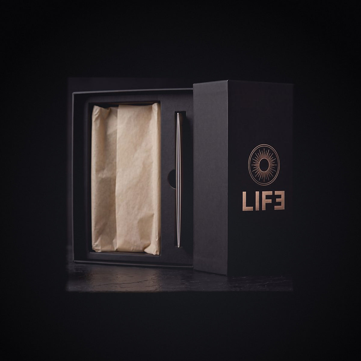 The LIF3 Vitamin D3 gift box open, cream tissue and fitted tray, radiant sun crest in champagne-gold foil on the lid