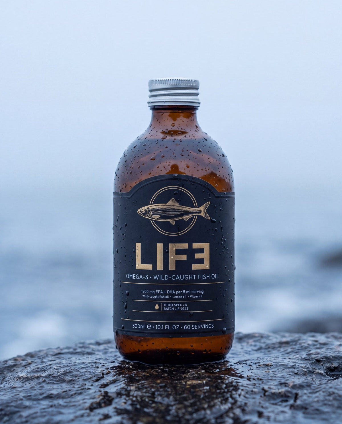 LIF3 Omega-3 wild-caught fish oil, 300 ml, on a wet rock at the shoreline